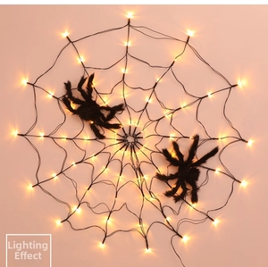 Detail view of warm yellow LED spider web lights with black furry spider decorations