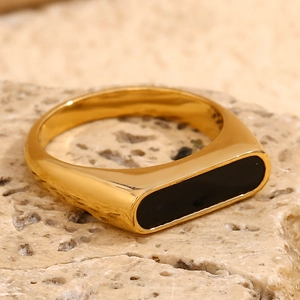 Macro detail of 18K gold-plated stainless steel ring with elegant black rectangular inlay