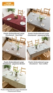 Detail of waterproof linen tablecloths in various colors with decorative tassel edges