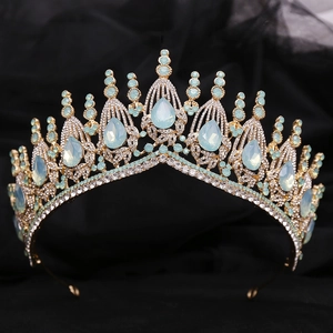 Golden Baroque bridal crown with blue rhinestones on black fabric background