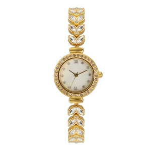 Detailed macro of golden mermaid watch with leaf-shaped band and crystal bezel