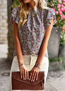 Detail of light blue floral blouse featuring ruffle sleeves and elegant high neckline
