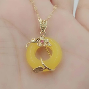 Minimalist titanium steel necklace with a ginger yellow donut pendant and gold floral accents