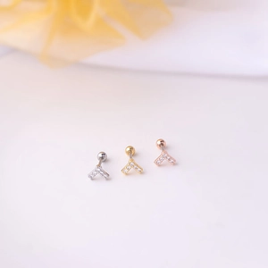Detailed view of V-shaped stainless steel ear studs in silver, gold and rose gold with gems