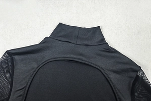 Detail of high neck mesh sleeves and hollow out design on black bodycon dress