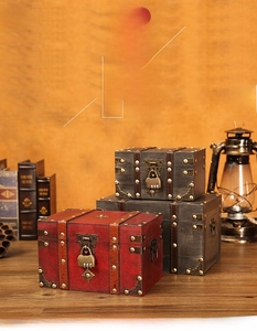 Three vintage wooden storage boxes with combination locks and metallic rivets on display
