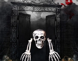 Detailed view of Halloween skeleton head and hands set with aged bone finish on garden ground