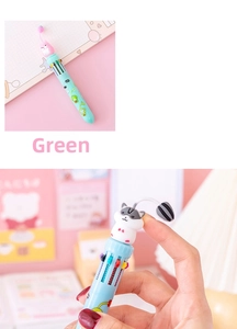 Detailed close-up of a multi-color ballpoint pen with a cute cartoon animal pendant topper