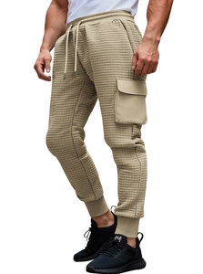 Detail of khaki waffle texture cargo pants with side pockets and adjustable drawstring