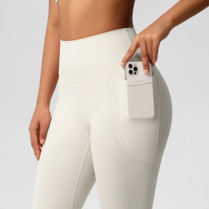 Close-up of high-waist yoga leggings featuring a functional side pocket holding a smartphone