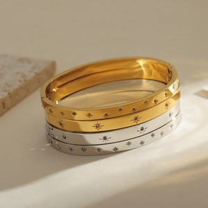 Gold and silver stainless steel cuff bracelets with sparkling star and diamond engravings