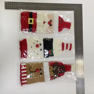 Detailed view of knitted Santa, snowman, and reindeer wine bottle covers with measurements