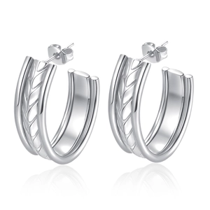 Macro detail of silver layered hoop earrings with textured wheat pattern and butterfly clasp