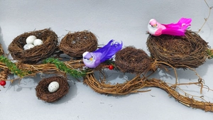 Detailed set of faux bird nests with colorful birds, speckled eggs and berry accents