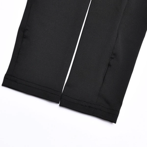 Close-up of high-quality stitching and hem detail on black elastic athletic fabric