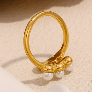 Macro detail of French style 18K gold plated beaded ring with three white pearls