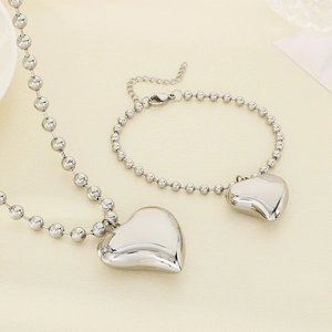 Polished stainless steel jewelry set featuring bead chain necklace and heart pendant