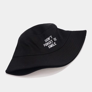 Classic black bucket hat with white DON'T FORGET TO SMILE embroidery shown from a 45-degree angle