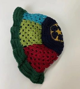 Detailed view of handmade crochet bucket hat with colorful patchwork and star pattern