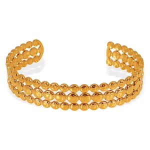 Elegant gold open bangle with triple-row embossed dot texture on a white background