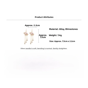 Detailed size view of gold tassel earrings with pink heart rhinestones and star pendants
