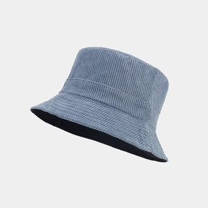 Detailed close-up of blue corduroy texture and black inner lining of bucket hat