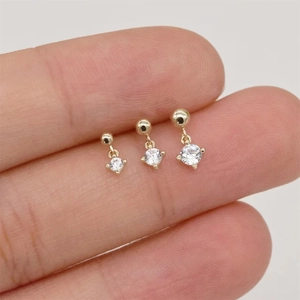 Detailed view of three sizes of S925 silver gold-plated stud earrings on a finger