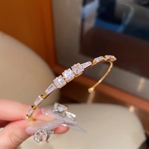 Close-up of 18K gold plated cuff bracelet with square and rectangular cubic zirconia
