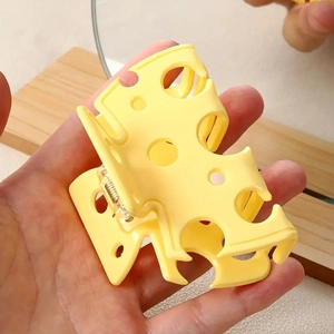Creative yellow hollow cheese shaped hair claw clip for a cute ponytail hairstyle