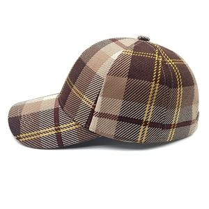 Macro detail of the classic plaid pattern and fine stitching on the stylish baseball cap