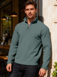 Detail of metal zipper and stand collar on men's solid color fleece sweatshirt