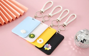 Detailed view of colorful cartoon card holders with 3D floral charms and wrist straps