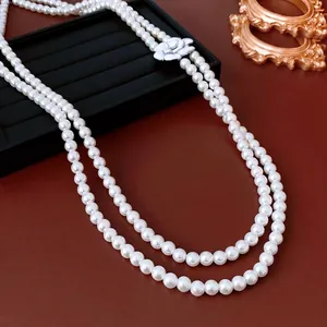 Double-layer glass pearl necklace with white camellia pendant in French vintage style