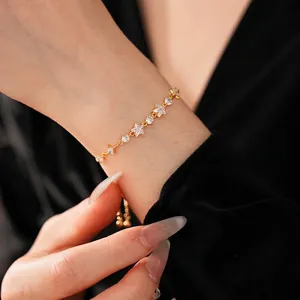 Elegant gold star bracelet with sparkling cubic zirconia on female wrist for a luxury look