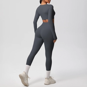 Side view of dark charcoal grey seamless high-waist yoga pants and cropped long sleeve top