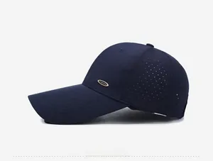 Detail of dark blue mesh baseball cap with laser-cut holes and gold fashion emblem