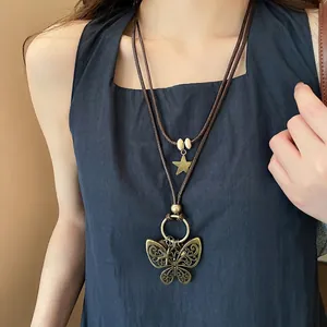 Vintage bronze butterfly pendant necklace with wooden beads and layered wax cord strings