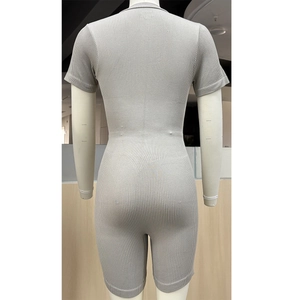 Back view detail of gray seamless ribbed sports romper showing knit texture and lifting cut