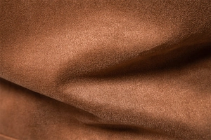 Close-up of the premium brown suede fabric texture with soft pile and smooth matte finish