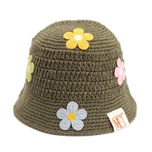Detail of army green crochet bucket hat featuring colorful 3D handmade floral knit patterns