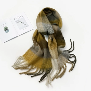 Close-up of mustard yellow and grey checkered scarf with soft mohair texture and fringes