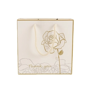 Elegant cream paper gift bag with golden rose pattern and Thank You text print