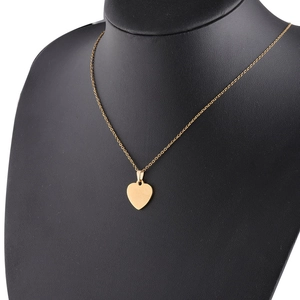Golden heart pendant necklace displayed on a black bust model with a thin chain design