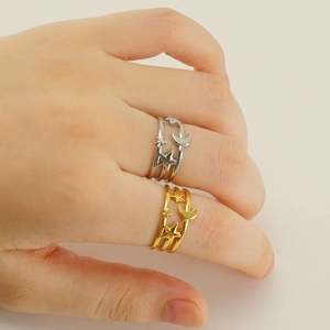 Star and moon layered open ring in gold and silver finish shown on hand