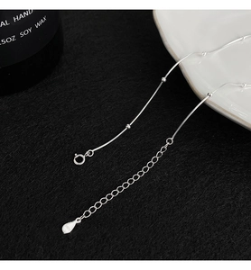 Macro view of S925 sterling silver snake chain with spring clasp and teardrop tag
