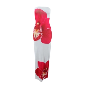Detailed view of large red floral patterns on a white strapless slim-fit maxi dress