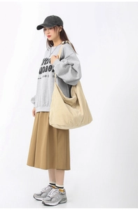 Beige corduroy shoulder bag styled with a grey sweatshirt and casual brown skirt