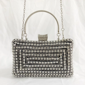 Detail of silver evening clutch featuring sparkling rhinestones in a geometric pattern