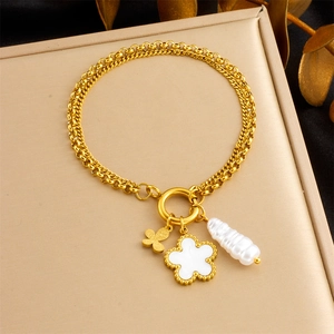 Elegant gold double-layered bracelet with butterfly, white flower, and seashell charms