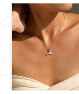 Detailed view of S925 silver necklace with elegant pearl mermaid tail pendant on model